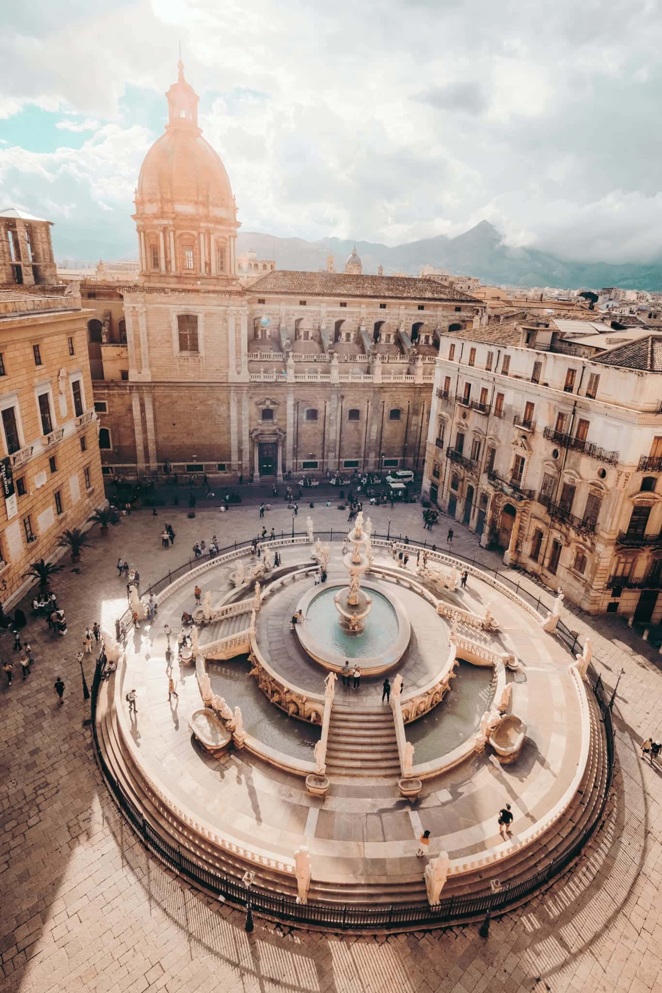 The Fontana Pretoria in Palermo seen from above, with a domed church behind it